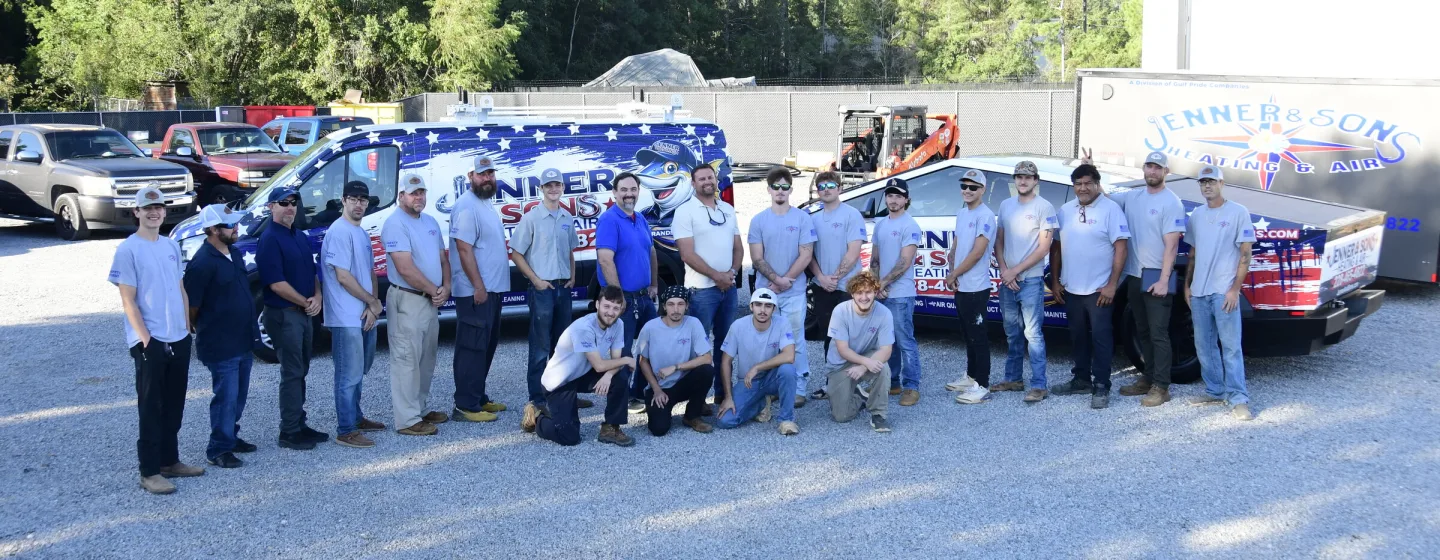 The Jenner & Sons Heating & Air team in front of the company van and Cybertruck